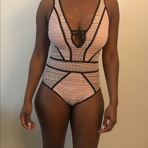Light pink and black body suit